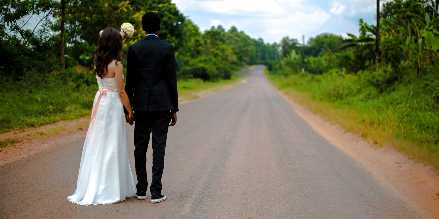 bride and groom standing in road